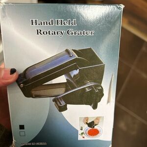 Hand held rotary grater